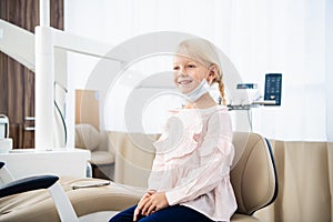 A satisfied little dentist patient showing her perfect smile aft