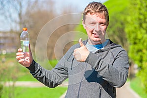 Satisfied man with a bottle of water