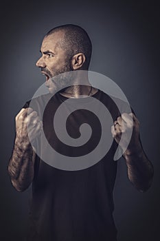 Satisfied man posing with clenched fists as a sign of success