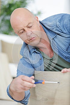Satisfied man tightening screws