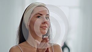 Satisfied model moisturizing face bath closeup. Lady applying facial foundation