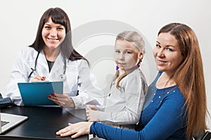 Satisfied mom with a child at the pediatrician`s appointment