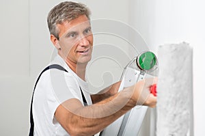 Satisfied Painter Painting Wall