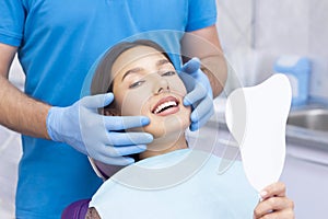 Satisfied patient at the dentist. who demonstrates his perfect smile after treatment