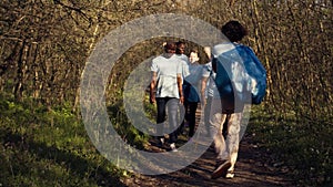 Satisfied people leaving the woods after a productive litter cleanup session