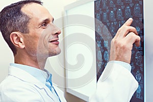 Satisfied radiologist smiling while examining mri scan