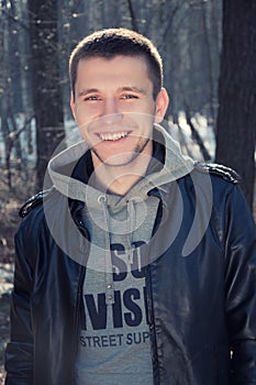 Satisfied smiling young man standing