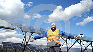 Satisfied solar power plant worker rejoices in success. Happy engineer. Freedom and independence concept,