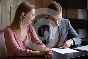 Satisfied wife and husband making investment deal, signing contract