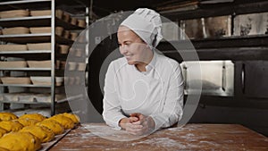 Satisfied woman baker proud of good work at bakery house