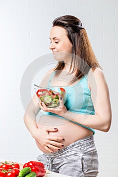 Woman eats a delicious vegetable salad