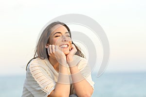 Satisfied woman smiling enjoying a beach day
