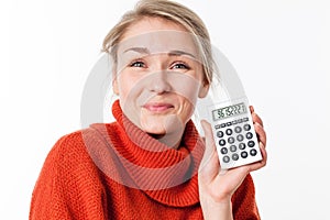 Satisfied young blond female student enjoying showing her calculator