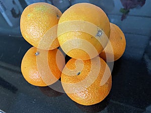 Satsumas sitting on a kitchen worktop