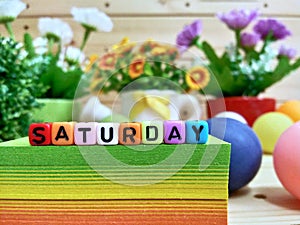 Saturday. Colorful cube letters on sticky note block.