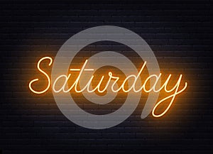 Saturday neon sign on brick wall background.