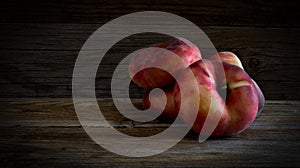 Saturn peaches on wooden table.