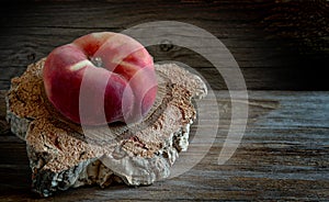 Saturn peaches on wooden table.