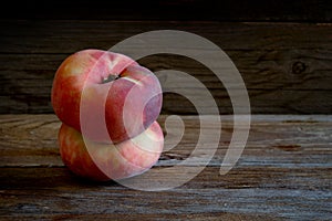 Saturn peaches on wooden table.