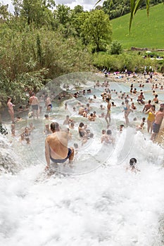 People bathing in natural spa of the hot Mill waterfalls of cascate dele Mulino. Grosseto, Tuscany,