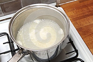 Sauce pan of rice in boiling water on a gas hob