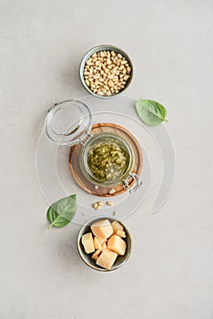 Sauce pesto in glass jar with fresh basil