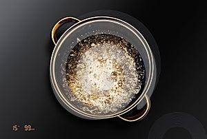 Saucepan on black induction cooktop