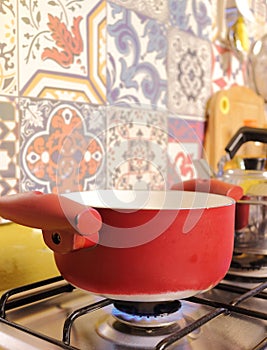 Saucepan cooking rice for lunch on stove. It`s a ordinary food for Brazilian people, everyday rice is cooked