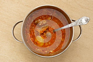 Saucepan with meat and sauce