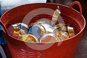 Saucepans casserole, cooking vessel with handle kept in basket in kitchen warehouse storage. Food Industry Utensils, Kitchenware