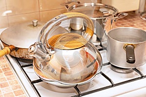 Saucepans, a frying pan and a kettle on the gas stove