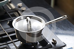 saucepans on modern kitchen range