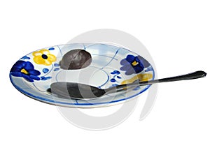 Saucer with chocolate candy and a teaspoon