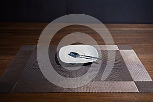 Saucer and spoon on table