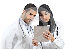 Saudi arab doctors working with a tablet