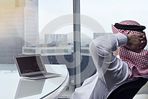 Saudi Arab Man Watching Laptop at Work Contemplating