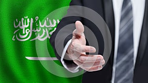 Saudi Arabia business, politics, cooperation and travel concept. Hand on flag of Saudi Arabia background