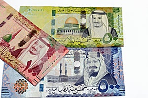 Saudi Arabia currency money banknote bills of 100, 50 and 500 riyals  on white background photo