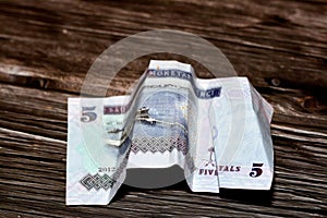 Saudi Arabia money of 5 SAR riyals isolated on wooden background