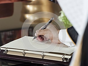 Saudi Arabian Man Hand Writing on A Notebook photo