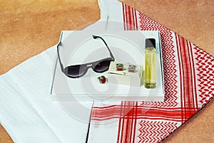 Saudi Arabian men wearing style accessories red white headscarf shemagh sunglasses perfume stone ring cufflinks decorated on