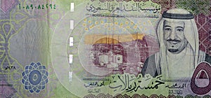 Saudi five riyals banknote, Saudi Arabian 5 riyals money background with the photo of king Salman, selective focus