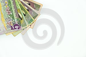 Saudi riyal banknotes over white