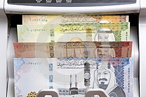 Saudi riyal in a counting machine photo