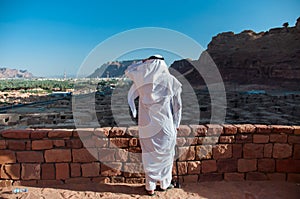 Saudian overlooking the old city of Al Ula, Saudi Arabia