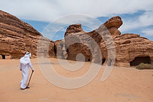 Saudian walking in MadaÃ®n Saleh archeological site, Saudi Arabi