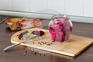 Sauerkraut with beets and spices in a glass jar