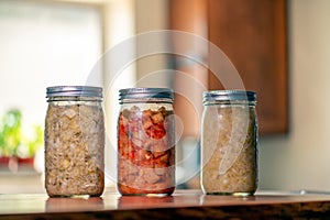 Sauerkraut, Dill kraut and kimchi in mason jars in home kitchen