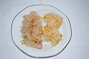 Sauerkraut with spiced potato mash on a white plate