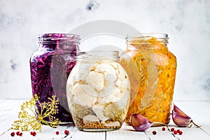 Sauerkraut variety preserving jars. Homemade red cabbage beetroot kraut, turmeric yellow kraut, marinated cauliflower and carrots